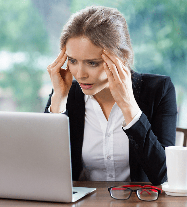 woman-with-headache-looking-laptop 1